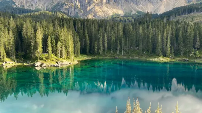 Iconic Carezza Lake in the Dolomites, surrounded by stunning alpine scenery