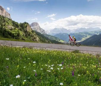 A Man on His Epic Road Bike Journey Through Passo Gardena in the Dolomites