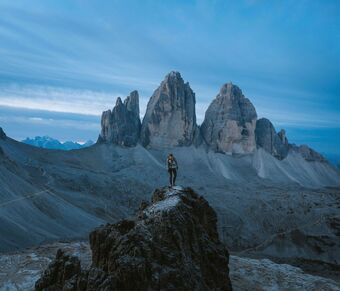 Man admiring the majestic Three Peaks of Lavaredo -Cortina d'Ampezzo, Italy