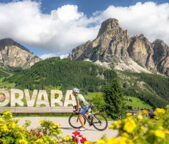 Man Cycling Through the Picturesque Corvara in Alta Badia