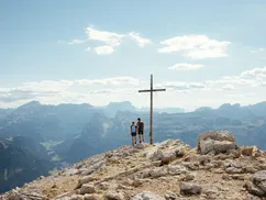 A Couple Enjoying a Stunning Dolomites Valley View on a Mountain Peak