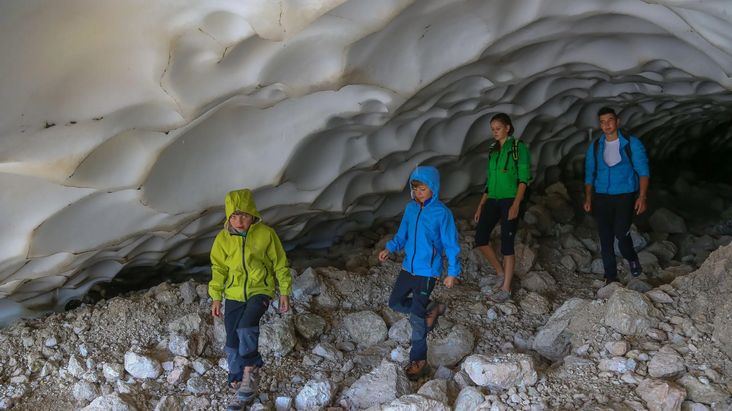 Family Discovering a Snow Cave at Santa Croce - Dolomites