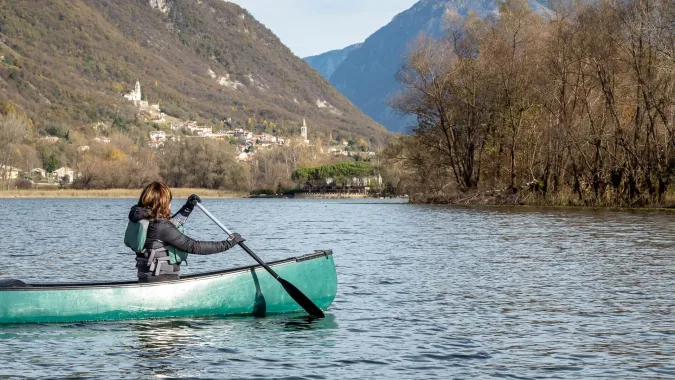 Woman in Canadian Canoe during a tour on lake Revine, Veneto -Italy