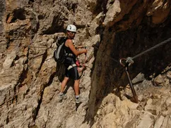 Helmeted climber on a via ferrata, Dolomites, Italian Alps