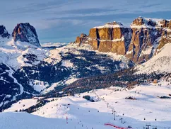 Skiing along the scenic Sellaronda route, Val di Fassa, surrounded by Dolomites peaks