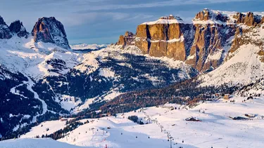 Skiing along the scenic Sellaronda route, Val di Fassa, surrounded by Dolomites peaks