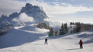 Skiing in the Alleghe resort with view on Mount Pelmo Dolomites