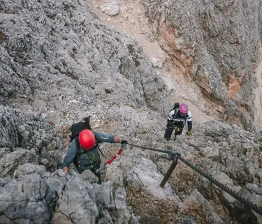 Moments during the traverse of a via ferrata in the Dolomites